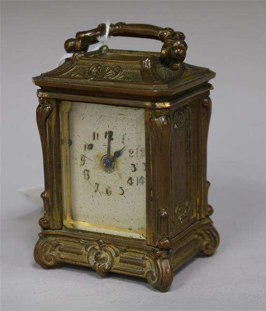A small ornate gilt brass carriage timepiece height 9cm (a.f.)